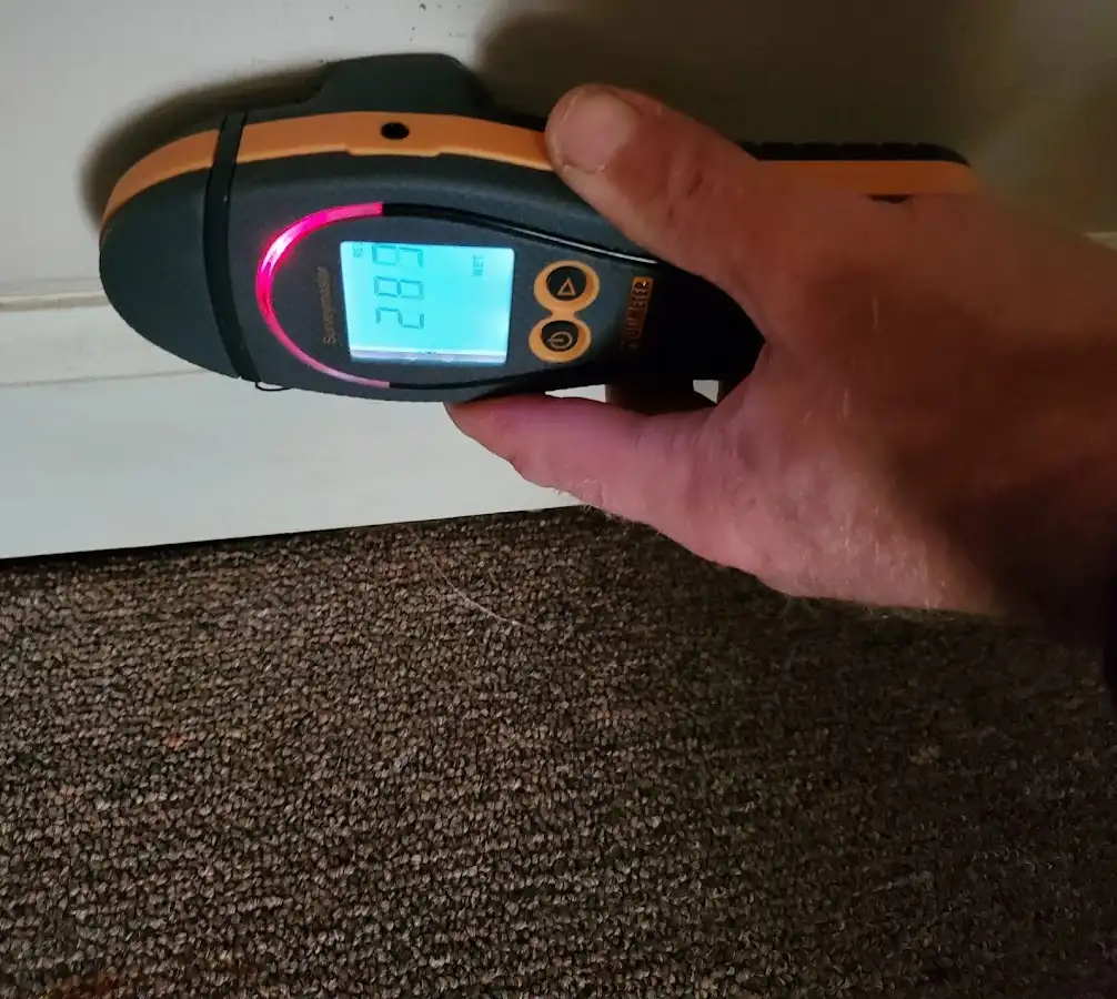 Moisture detection at baseboard during Storm Damage Restoration in Scappoose